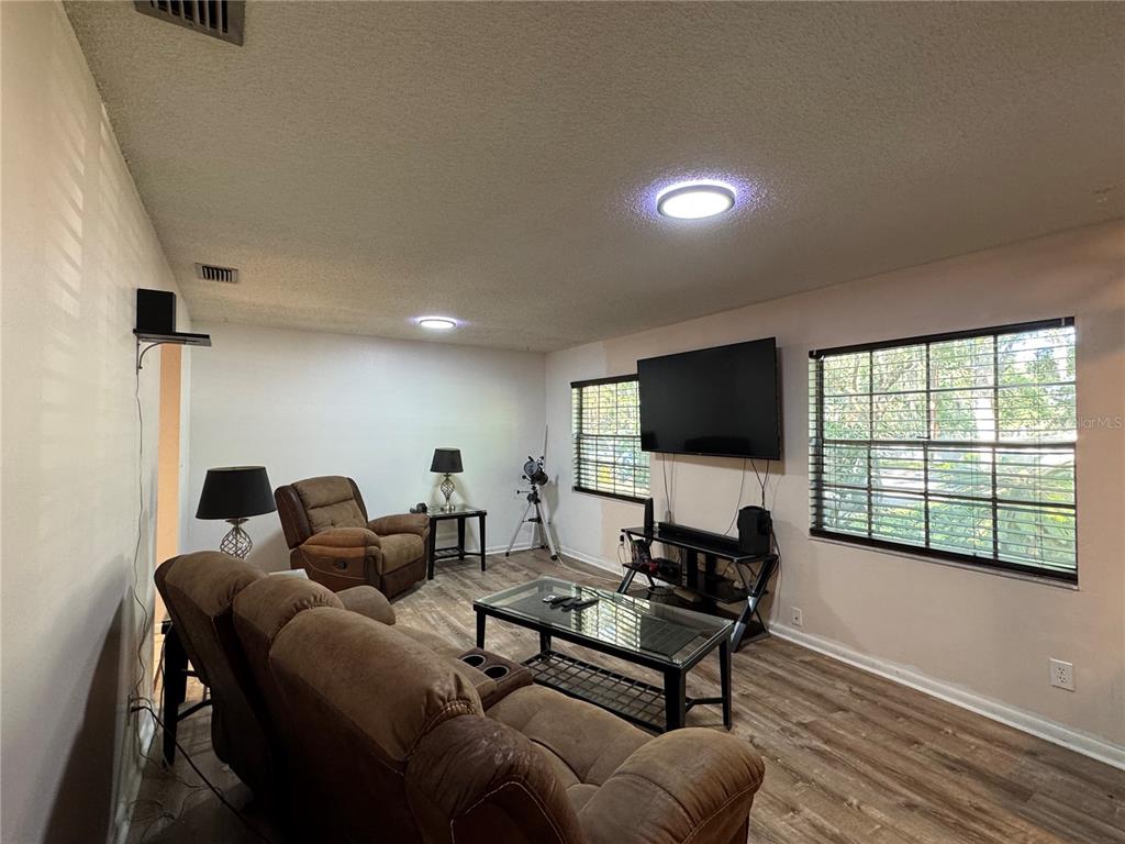 1703 North Taylor Road Brandon, FL 33510 - Photo 14 of 32 a living room with furniture and a flat screen tv