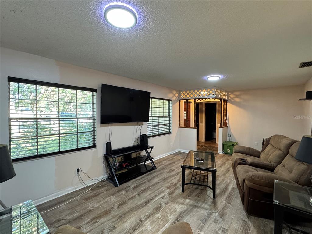 1703 North Taylor Road Brandon, FL 33510 - Photo 15 of 32 a living room with furniture and a flat screen tv