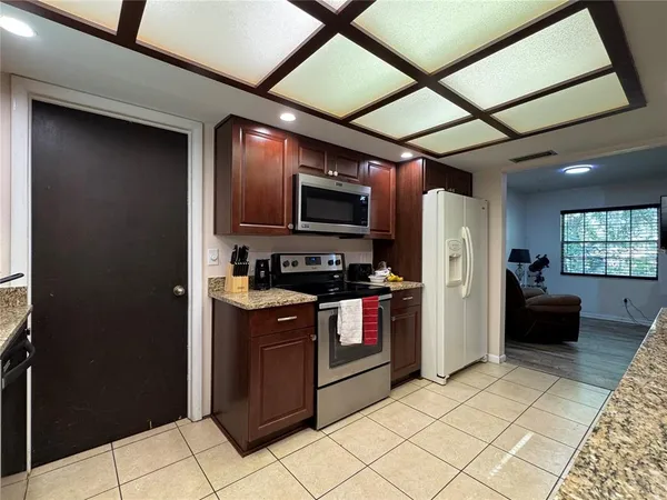 a kitchen with refrigerator cabinets and furniture