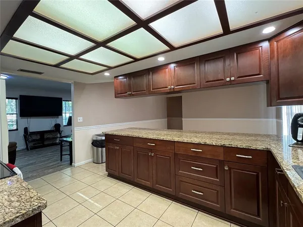a kitchen with granite countertop wooden cabinets and stainless steel appliances