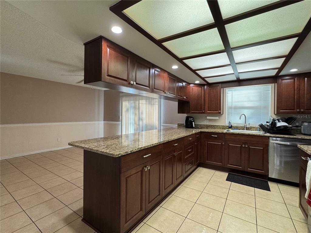 1703 North Taylor Road Brandon, FL 33510 - Photo 21 of 32 a kitchen with stainless steel appliances granite countertop a sink counter space cabinets and a stove