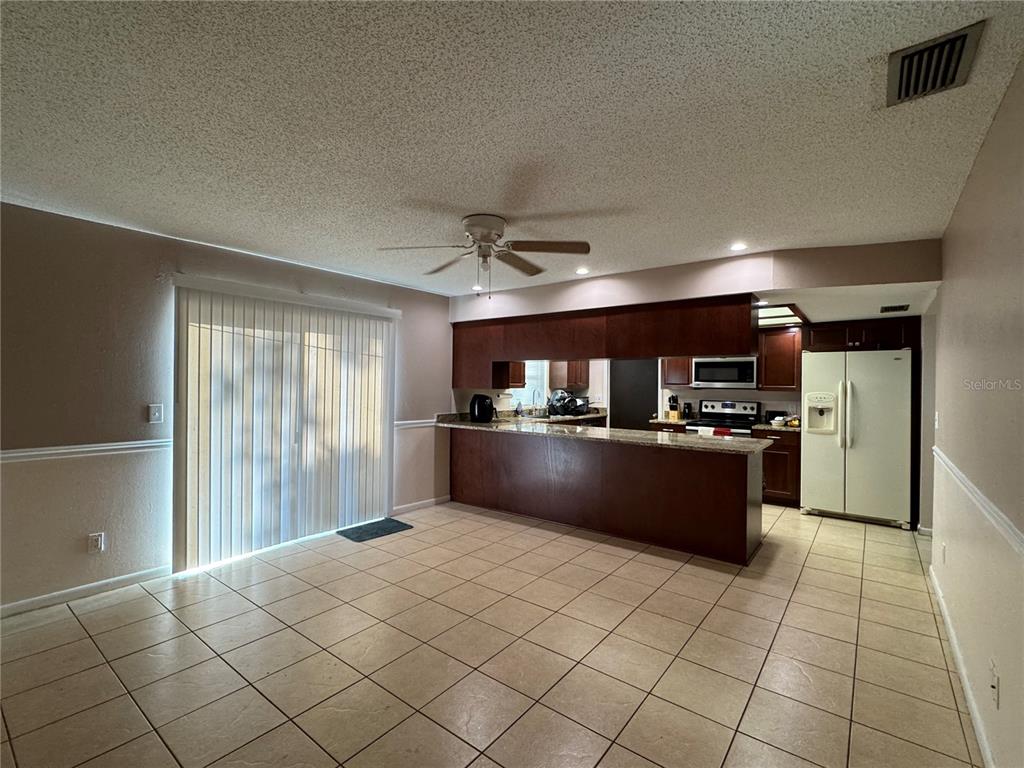 1703 North Taylor Road Brandon, FL 33510 - Photo 24 of 32 a large kitchen with kitchen island a sink counter and stainless steel appliances