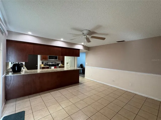 a kitchen with granite countertop a refrigerator and a sink