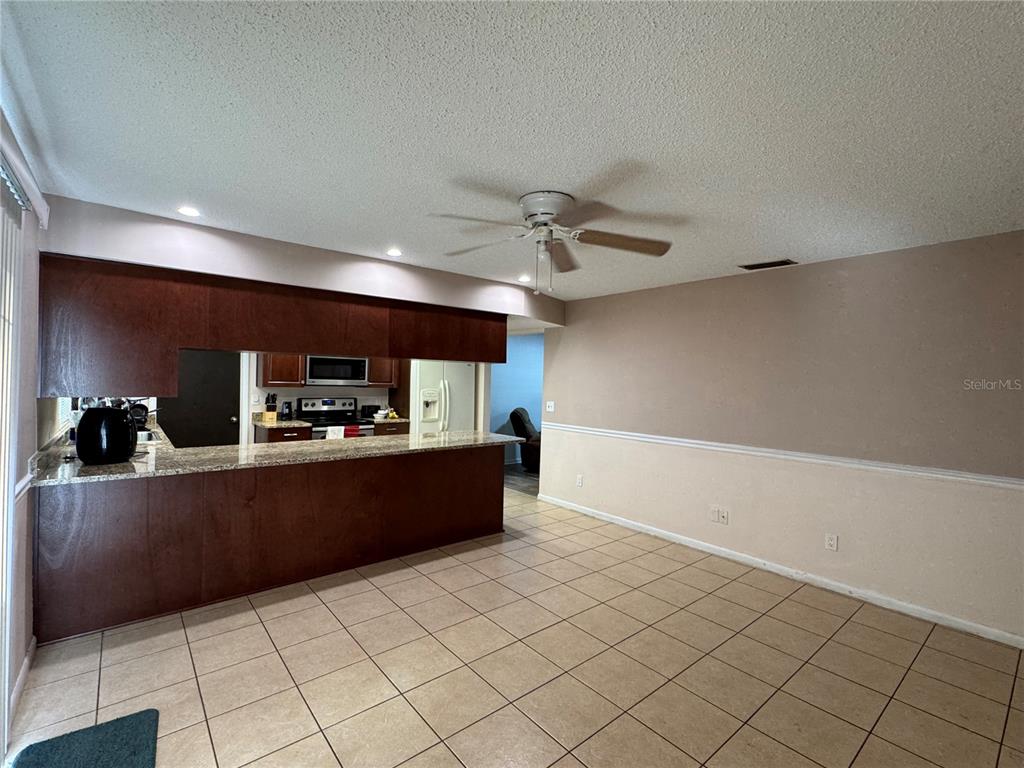 1703 North Taylor Road Brandon, FL 33510 - Photo 26 of 32 a kitchen with granite countertop a refrigerator and a sink