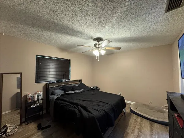 a bedroom with a bed and a chandelier