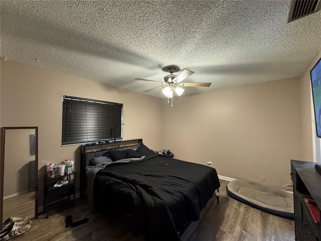 1703 North Taylor Road Brandon, FL 33510 - Photo 28 of 32 a bedroom with a bed and a chandelier