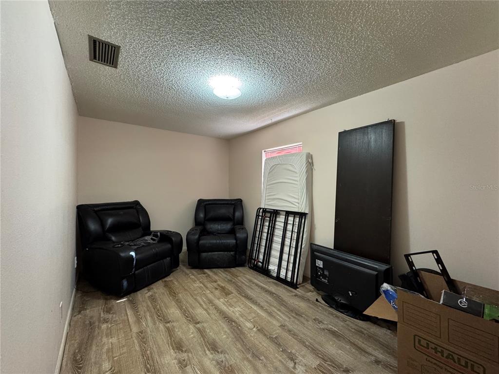 1703 North Taylor Road Brandon, FL 33510 - Photo 29 of 32 a living room with furniture and wooden floor