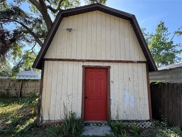 a small white house with a small yard plants