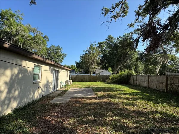 a view of a yard with large trees