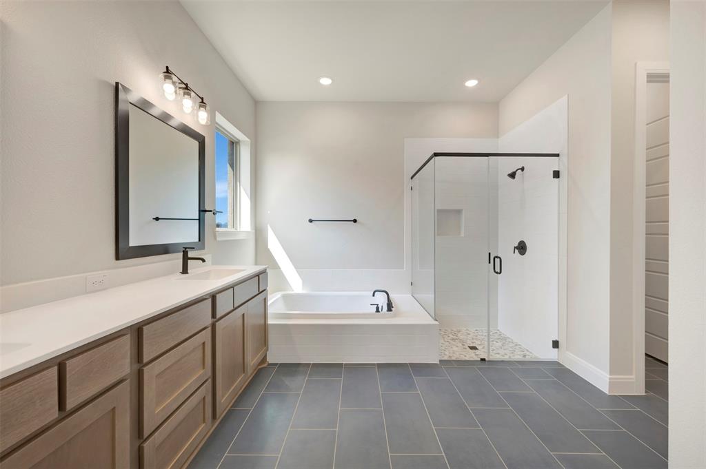 3575 Redbud Flower Trail Venus, TX 76084 - Photo 33 of 36 Bathroom with a shower stall, double vanity, a garden tub, recessed lighting, and dark tile patterned floors