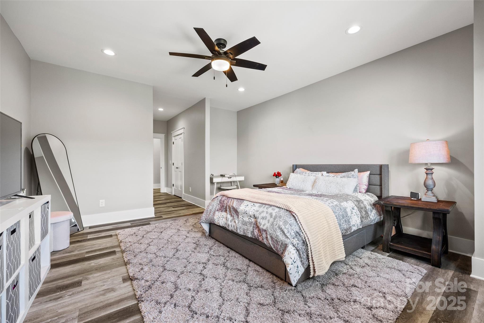 385 Squirrel Lane Lake Wylie, SC 29710 - Photo 26 of 48 a spacious bedroom with a bed and a chandelier