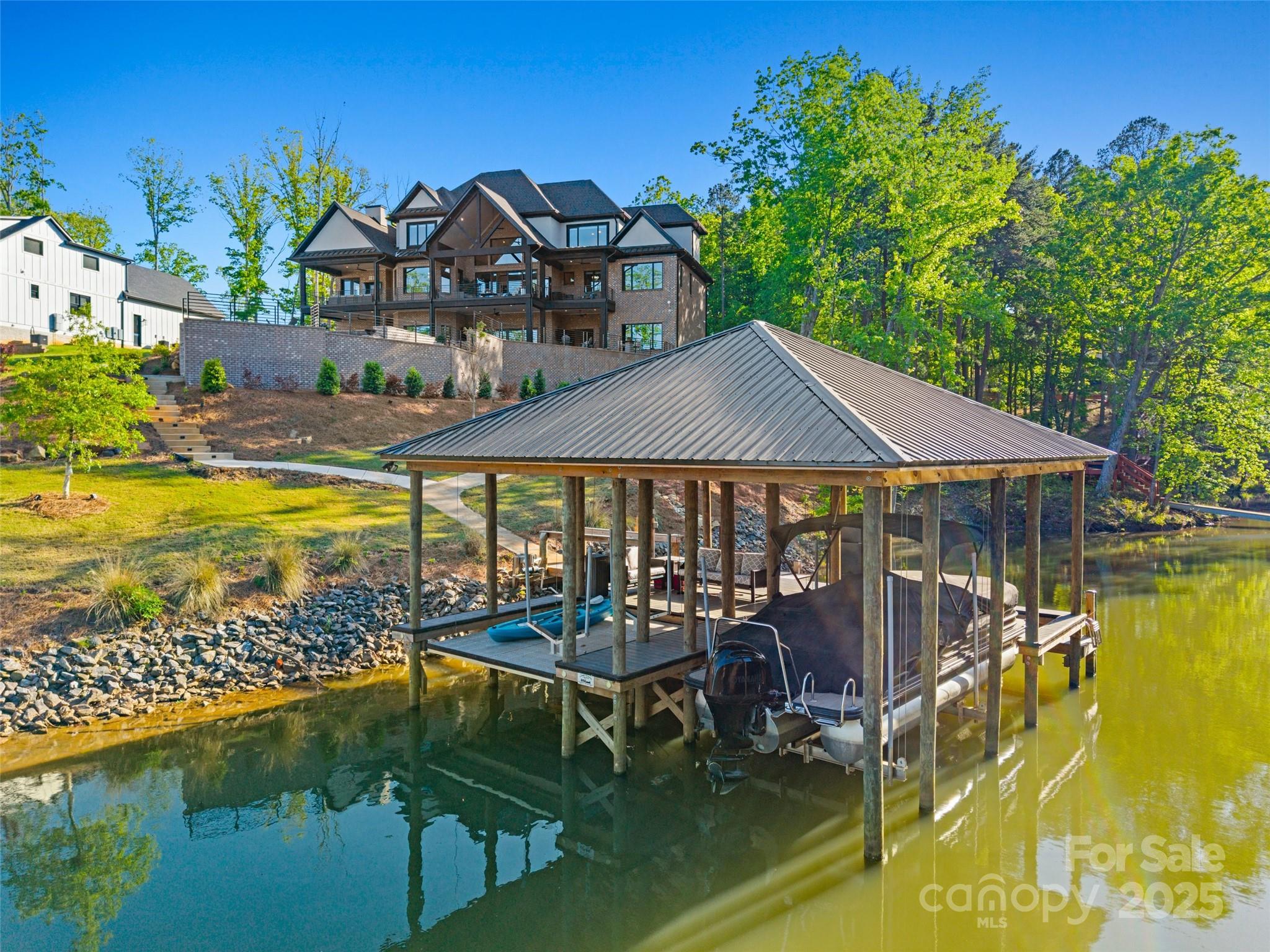 385 Squirrel Lane Lake Wylie, SC 29710 - Photo 43 of 48 a view of a swimming pool with lawn chairs under an umbrella