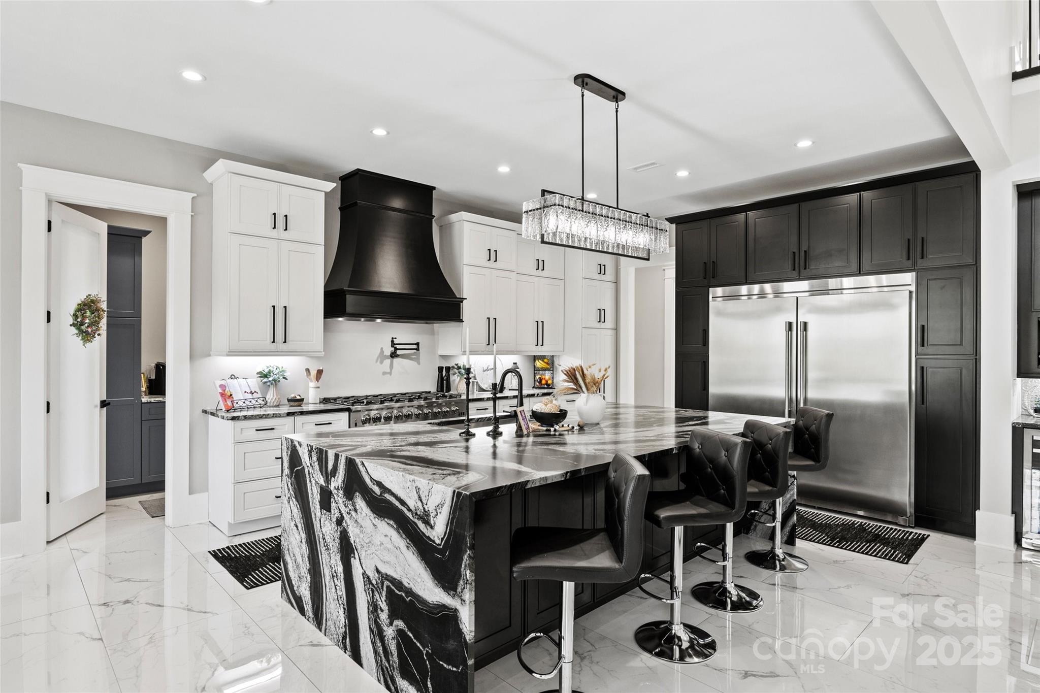 385 Squirrel Lane Lake Wylie, SC 29710 - Photo 8 of 48 a kitchen with stainless steel appliances a table chairs and a refrigerator