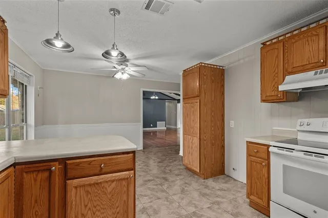 a kitchen with a cabinets and chandelier
