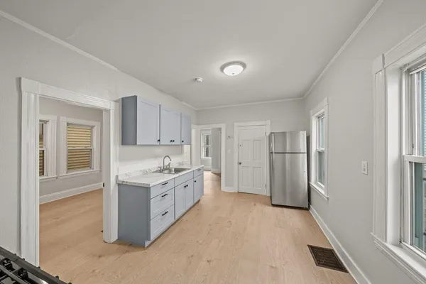 a kitchen with a sink and a refrigerator