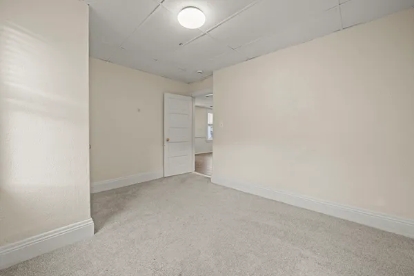 an empty room with closet and mirrors