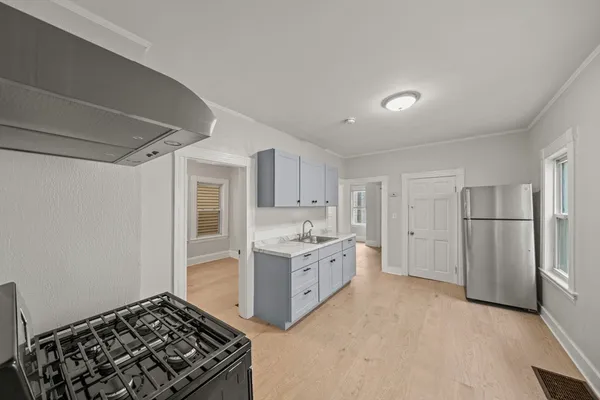 a kitchen with stainless steel appliances granite countertop a stove and a refrigerator