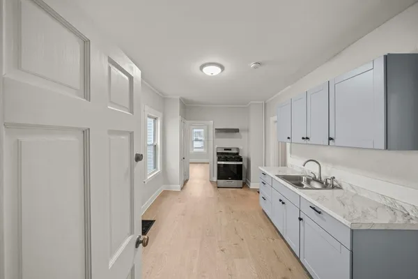 a kitchen with granite countertop a sink and cabinets