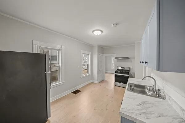 a kitchen with stainless steel appliances granite countertop a refrigerator and a sink