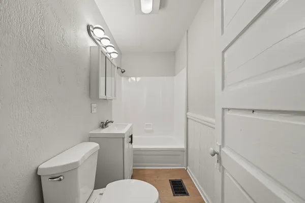 a bathroom with a toilet a sink and bathtub