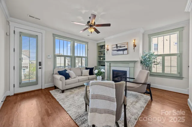 a living room with furniture a large window and a fireplace