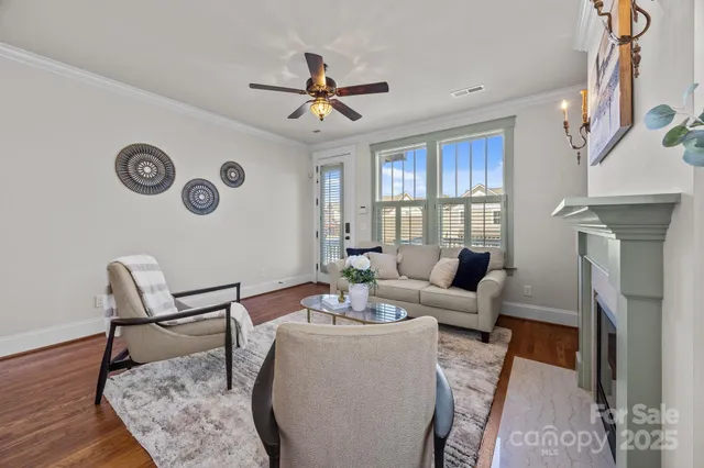 a living room with furniture a fireplace and a window