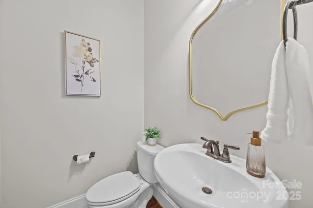 a bathroom with a sink mirror and toilet