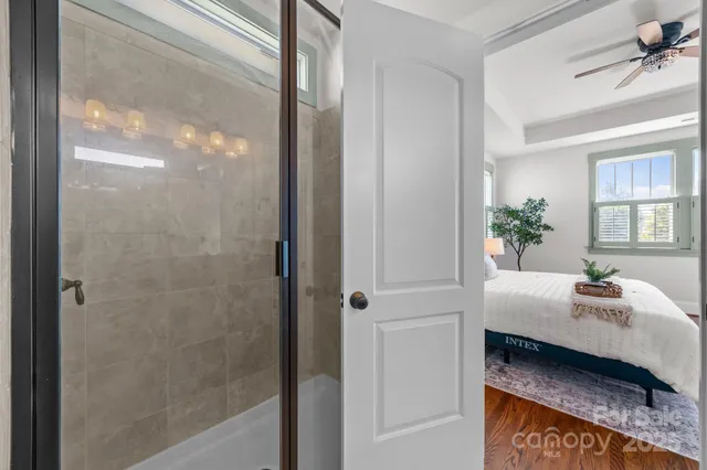 a en suite bathroom with a granite countertop sink and a mirror