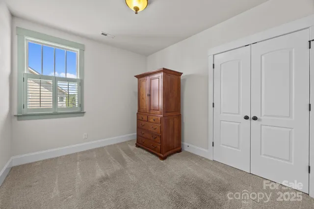 a view of an empty room with closet area