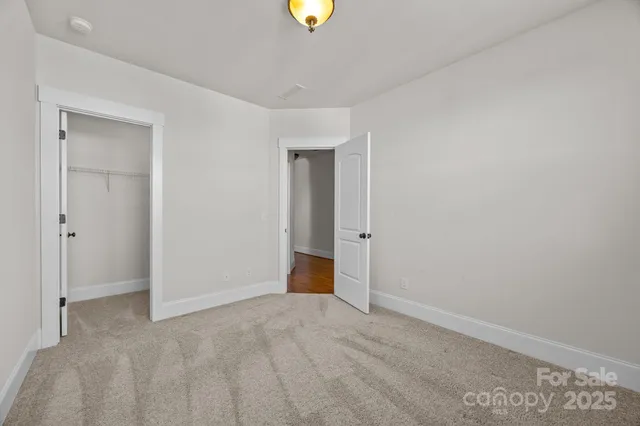 a bathroom with a granite countertop sink a toilet a mirror a bathtub and shower