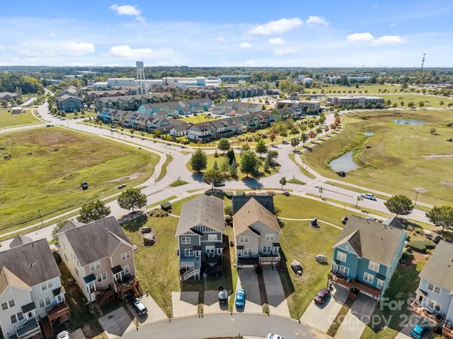 an aerial view of a house with garden space and street view