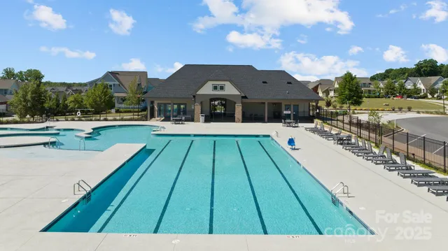 an aerial view of a house with swimming pool and patio