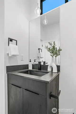 a kitchen with a sink and a mirror