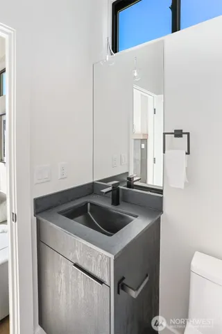 a close view of a sink and a toilet in a bathroom