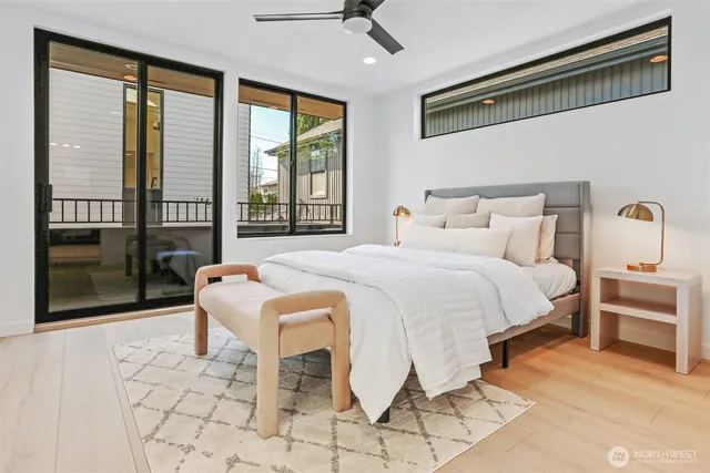 a bedroom with a bed and a large window