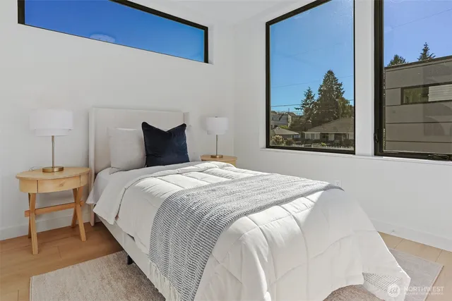 a bedroom with a bed and a painting on the wall