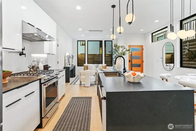 a kitchen with stainless steel appliances granite countertop a sink stove and refrigerator
