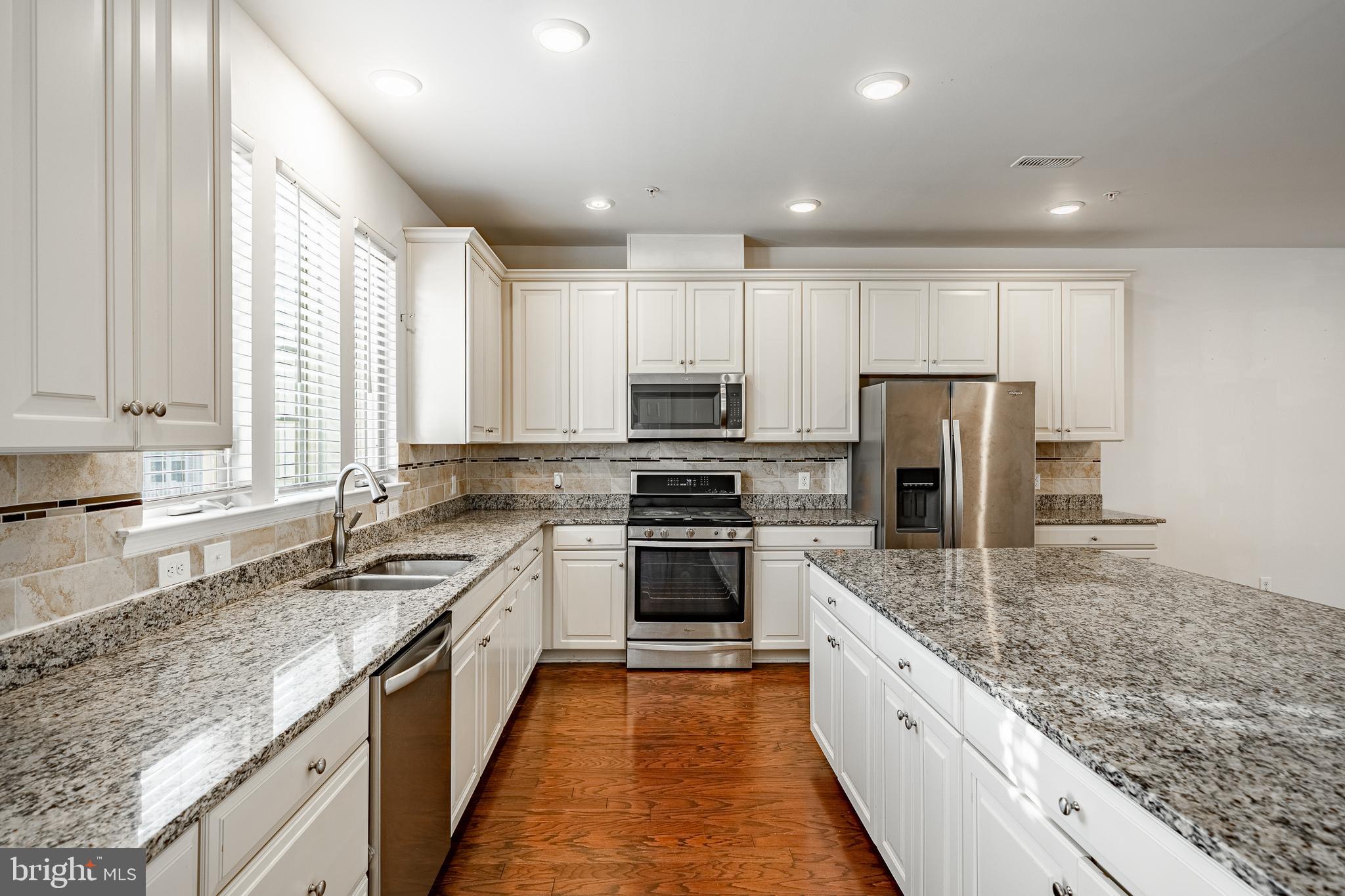 33 Addison Lane Malvern, PA 19355 - Photo 4 of 32 a large kitchen with granite countertop a large counter top stainless steel appliances and a sink
