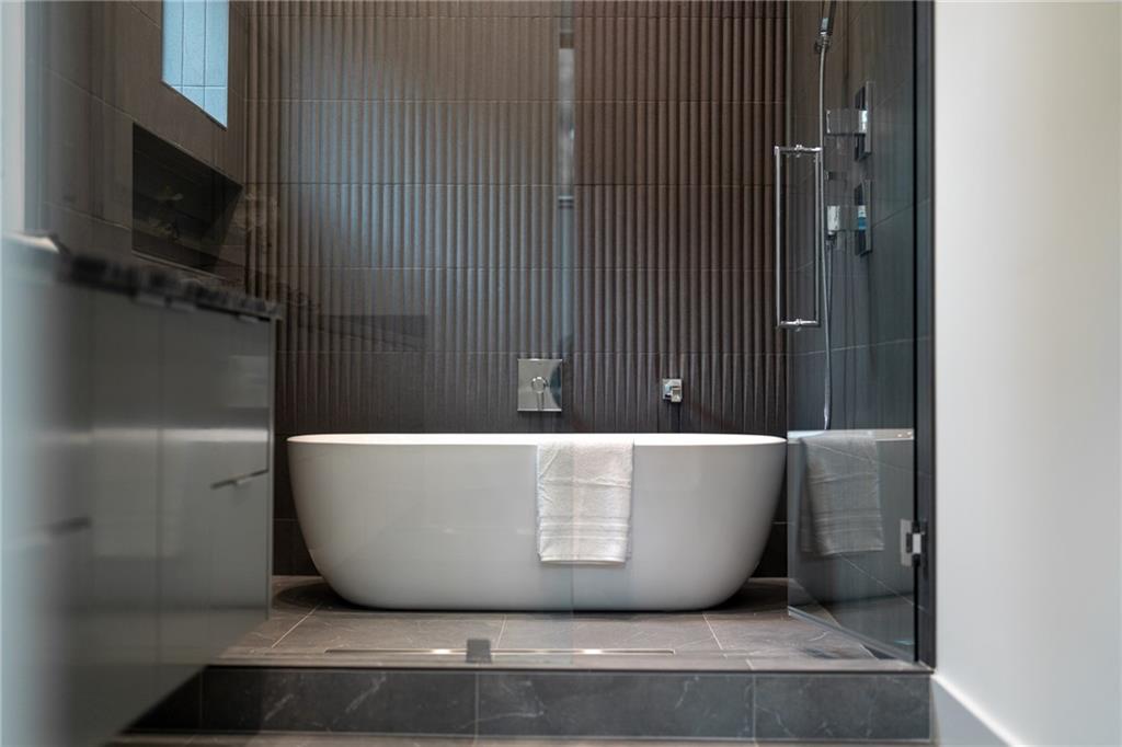 19 Spruell Springs Road Atlanta, GA 30342 - Photo 12 of 36 a white tub sitting next to a window