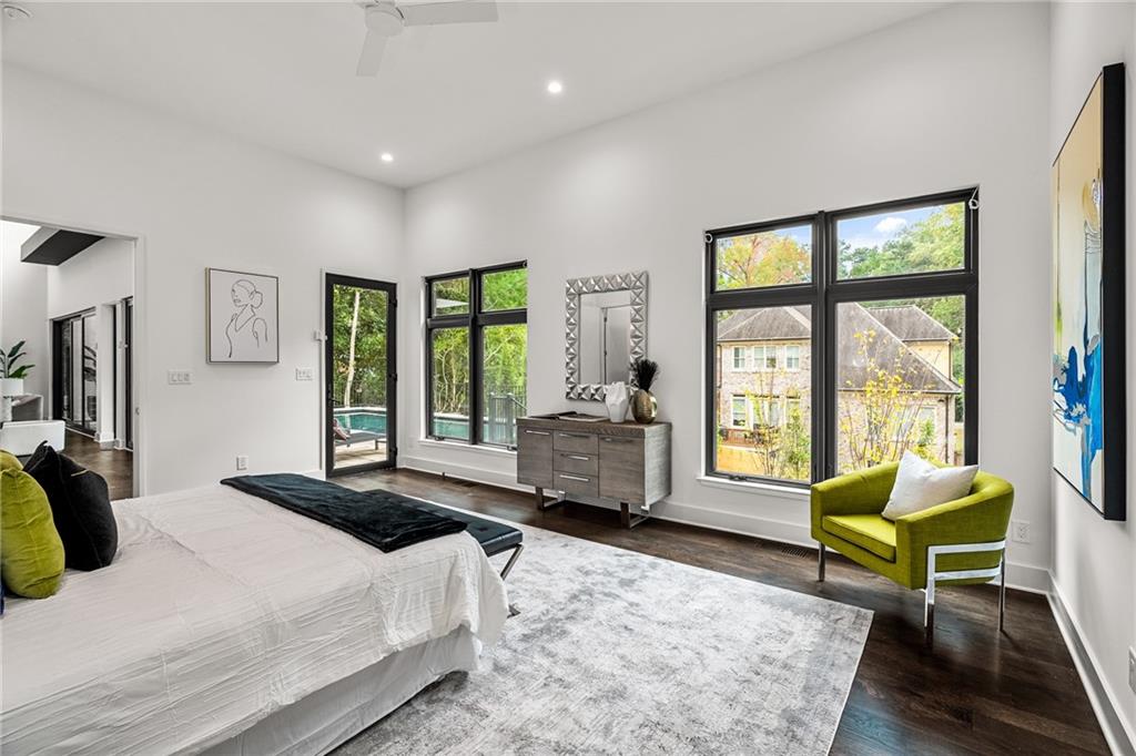 19 Spruell Springs Road Atlanta, GA 30342 - Photo 14 of 36 a spacious bedroom with a bed a large window with table and chair