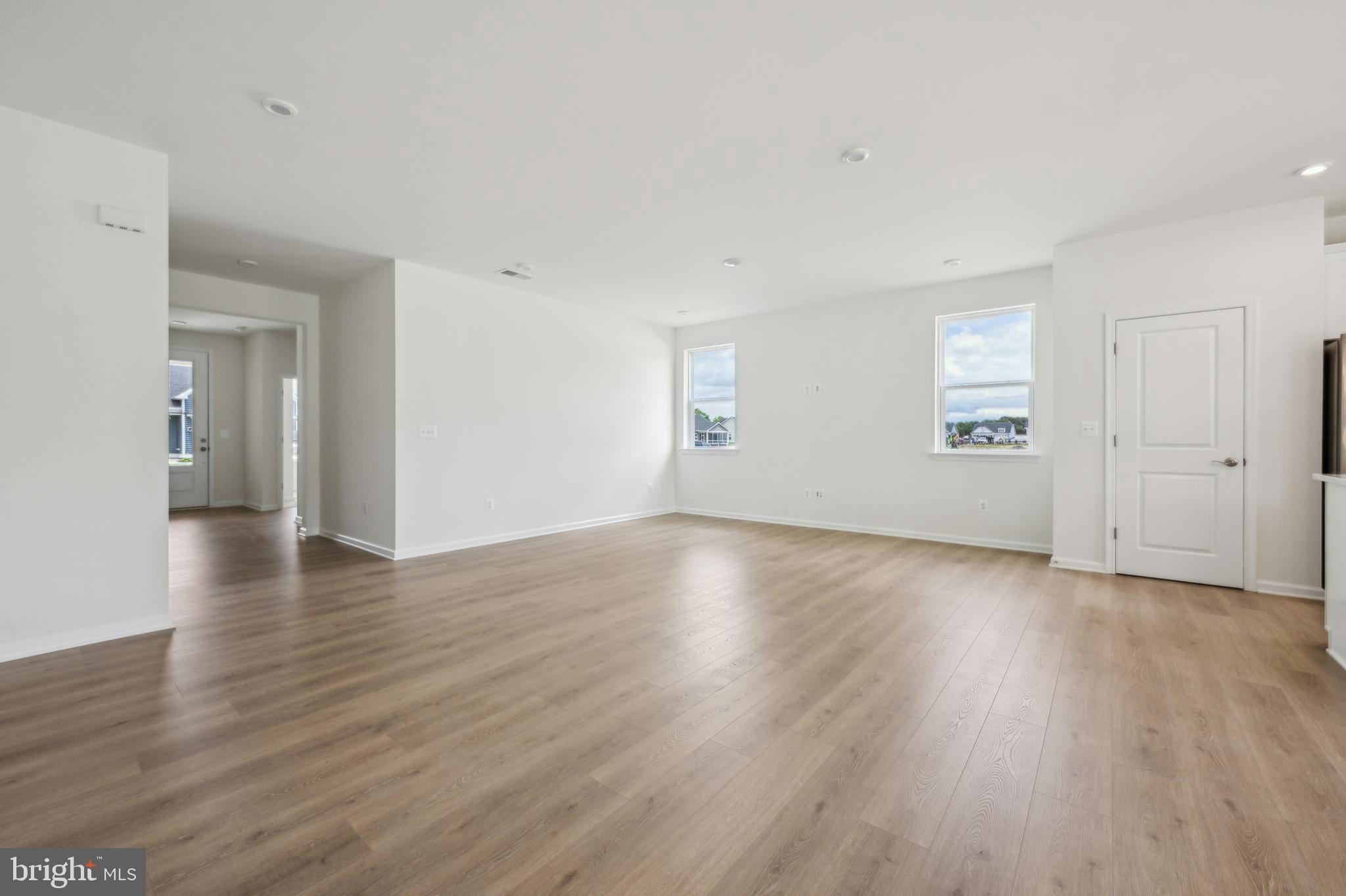 24755 Michael Isler Avenue Millsboro, DE 19966 - Photo 4 of 14 an empty room with wooden floor & windows and bathroom