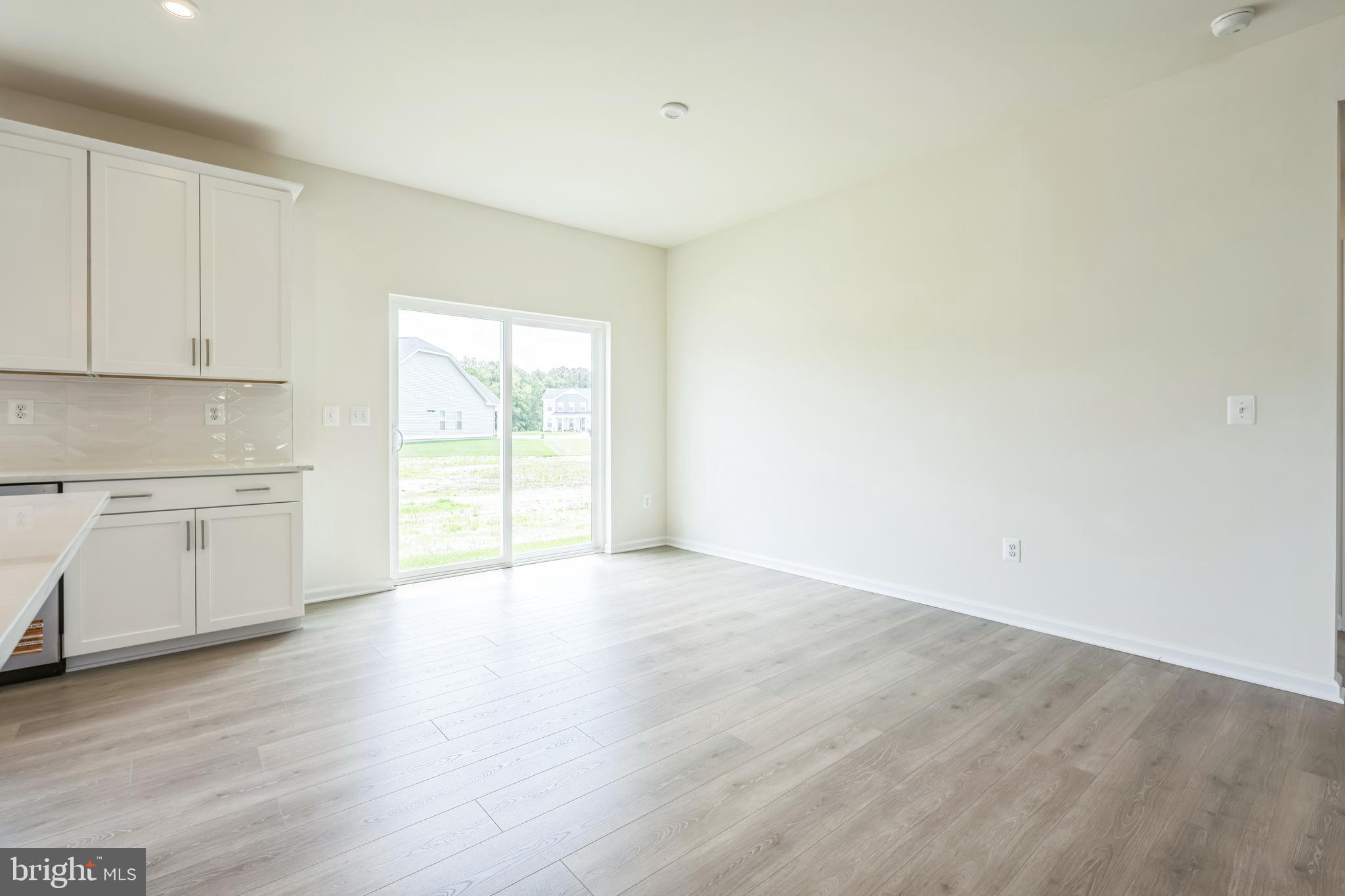 24755 Michael Isler Avenue Millsboro, DE 19966 - Photo 6 of 14 a view of a kitchen with wooden floor and a sink