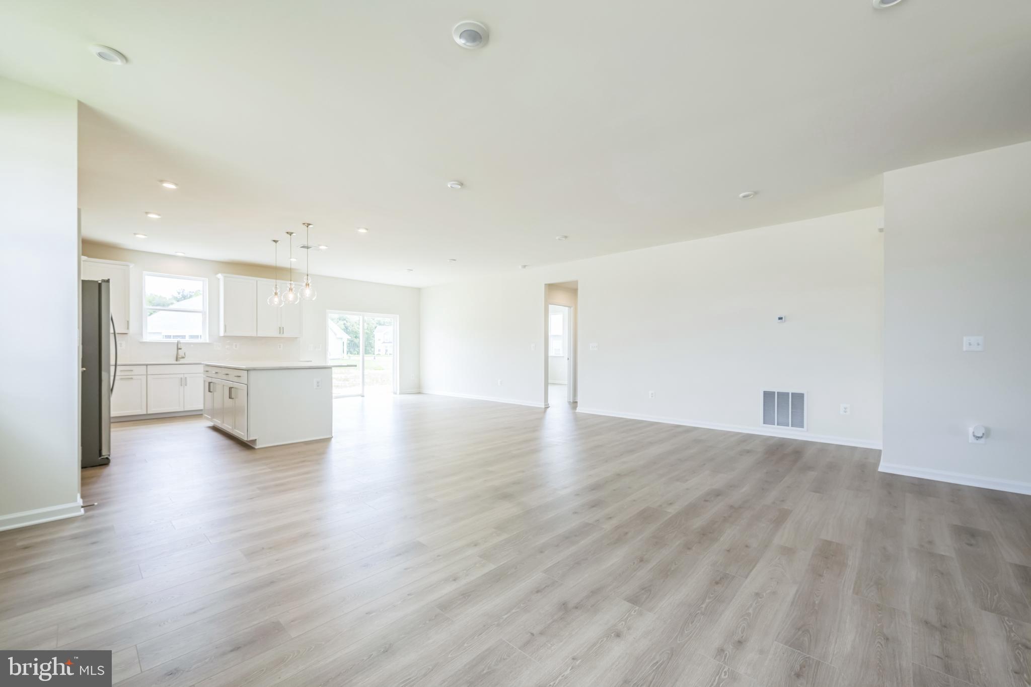 24755 Michael Isler Avenue Millsboro, DE 19966 - Photo 7 of 14 a view of a kitchen with a sink and a refrigerator