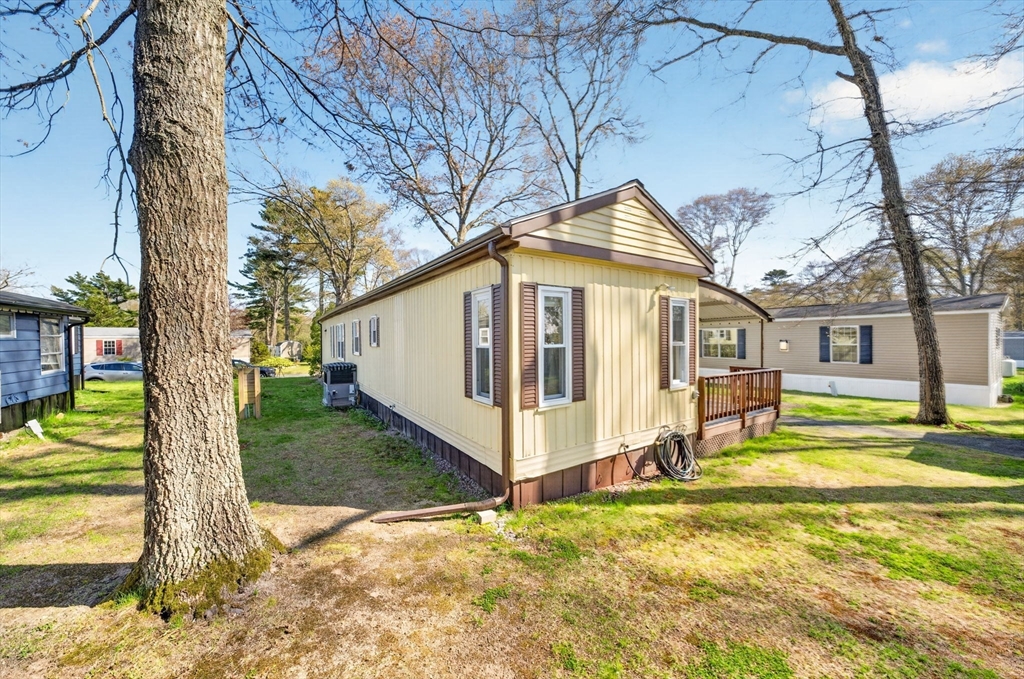 19 Timber Lane Wareham, MA 02571 - Photo 28 of 38 a view of a house with a yard patio and fire pit
