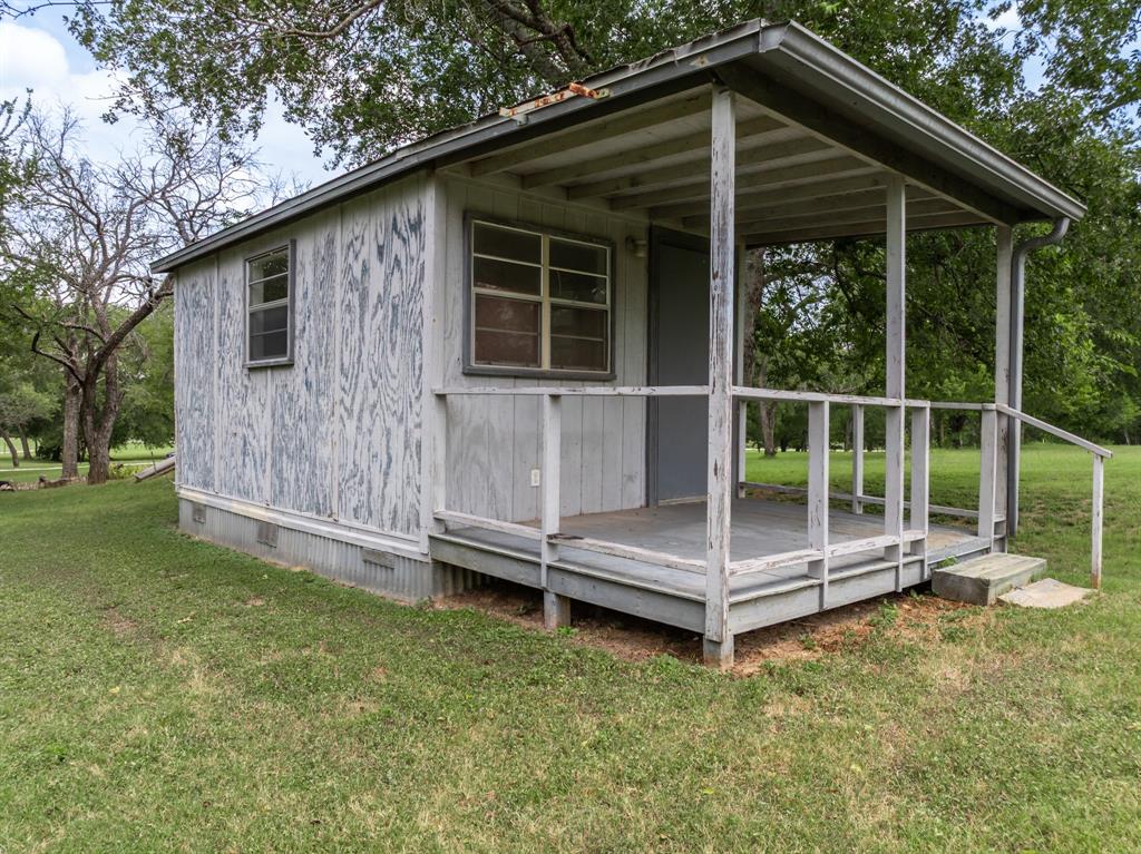 235 Country Drive Waco, TX 76705 - Photo 17 of 29 a view of backyard with large trees and a barn