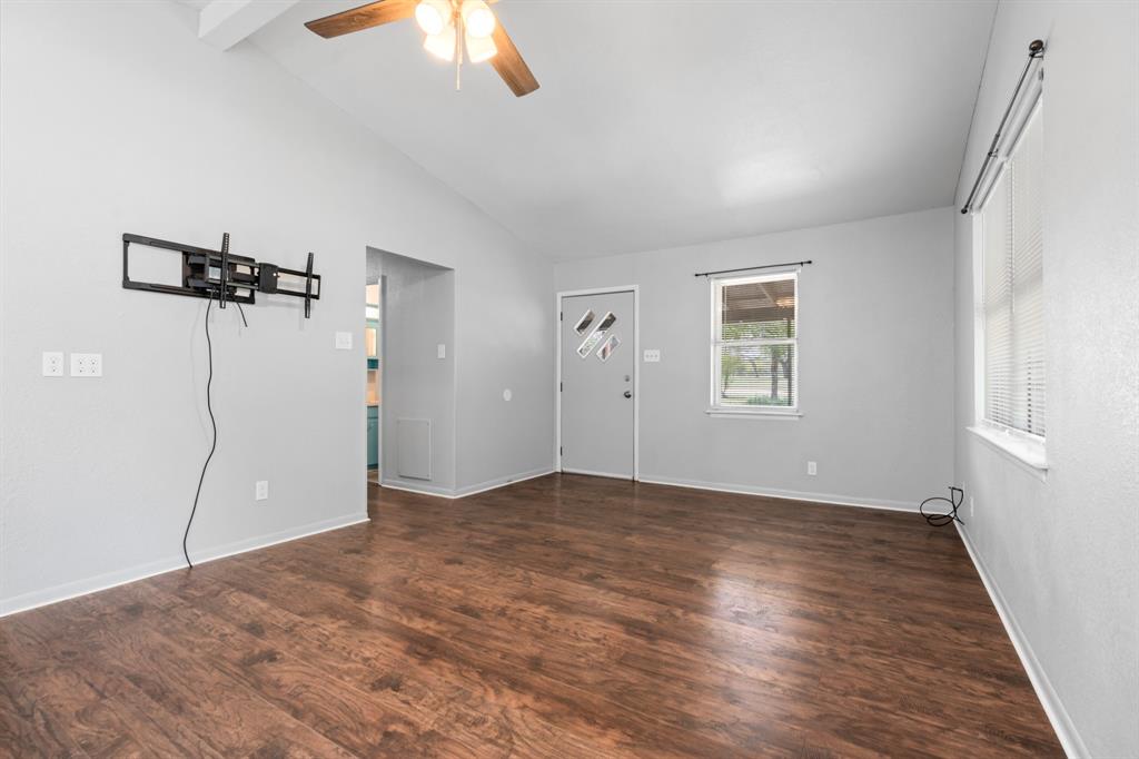 235 Country Drive Waco, TX 76705 - Photo 5 of 29 wooden floor in an empty room with a window