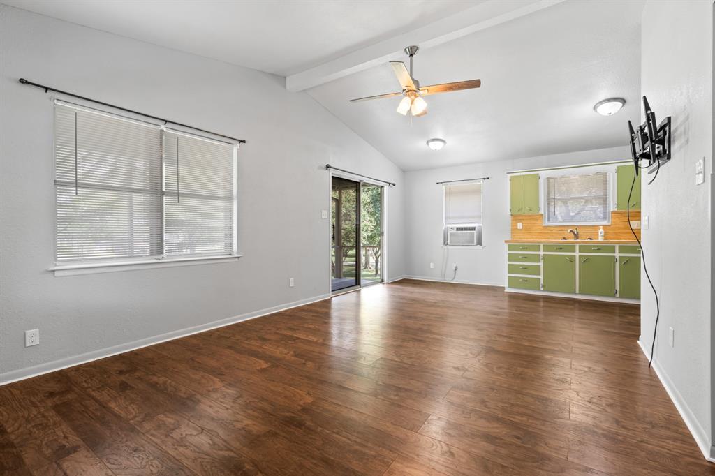 235 Country Drive Waco, TX 76705 - Photo 6 of 29 a view of an empty room with a window and wooden floor