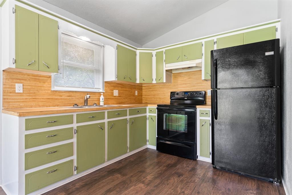 235 Country Drive Waco, TX 76705 - Photo 7 of 29 a kitchen with a refrigerator and a sink