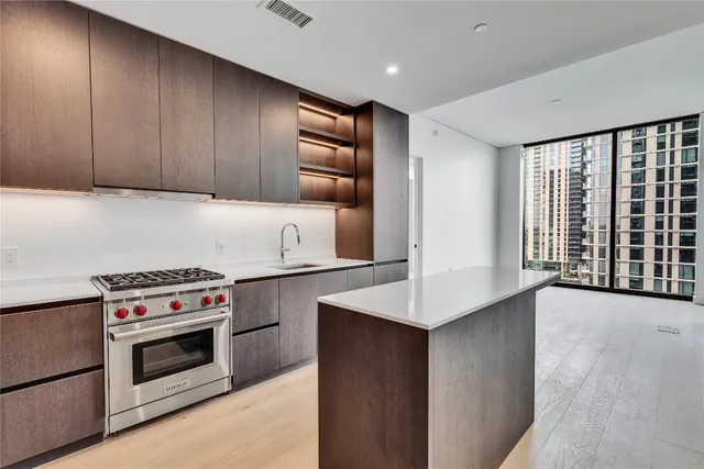 a kitchen with granite countertop a stove and a sink