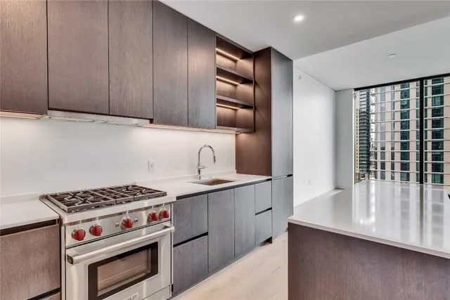 a kitchen with granite countertop a stove and a sink